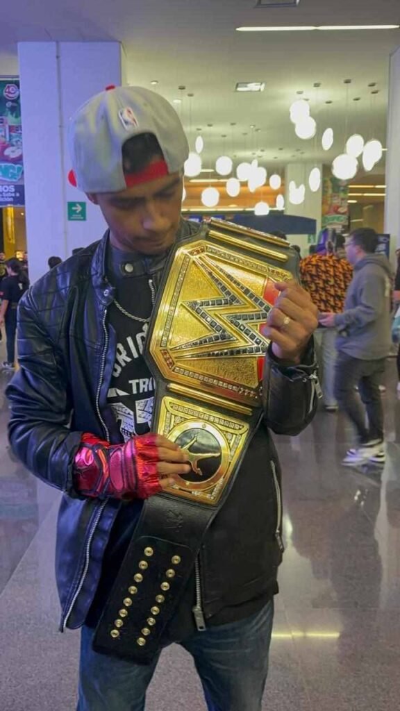 WWE championship belt on the shoulder of the young boy